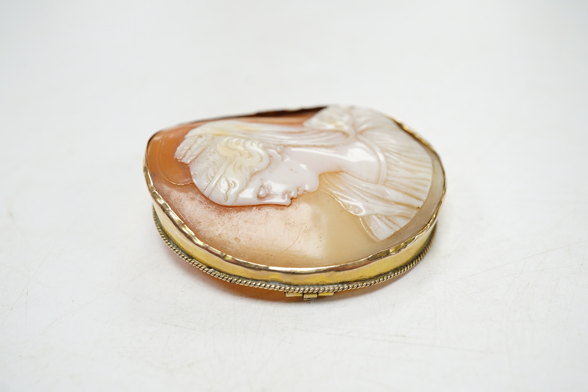 A yellow metal mounted oval cameo shell brooch, carved with the bust of a lady to dexter, 45mm. Condition - fair